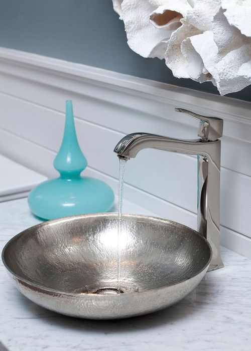 Vessel sink with blue vase on the counter